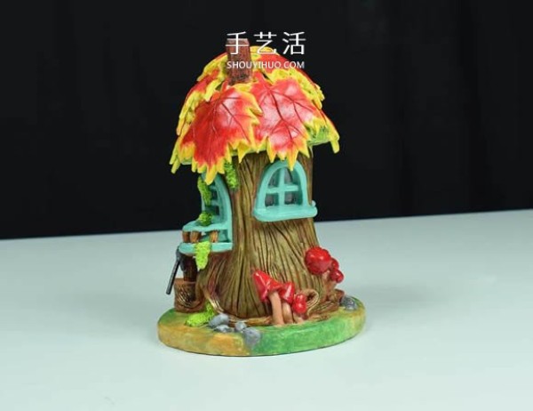 Handmade fairy house with paper clay and glass bottles