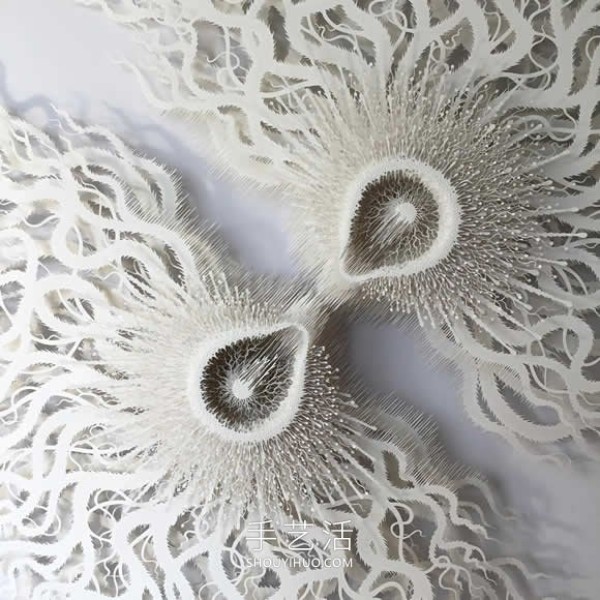 Intricate hand-cut paper sculptures that mimic microorganisms