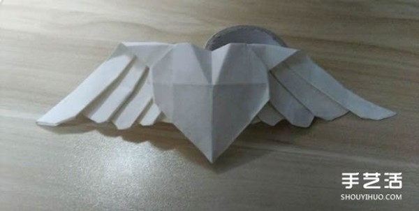 Flying origami heart with steps to fold a heart-shaped with wings