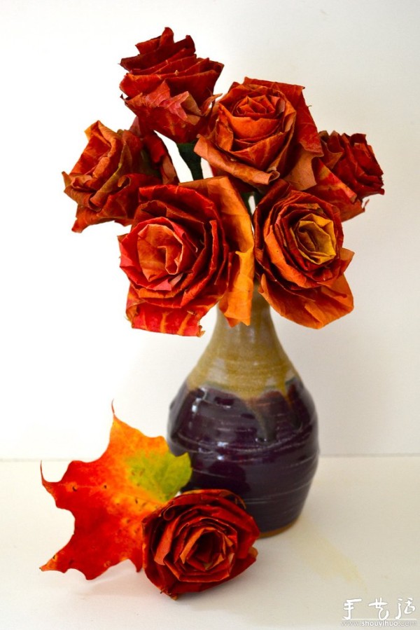 Handmade roses with fiery red maple leaves