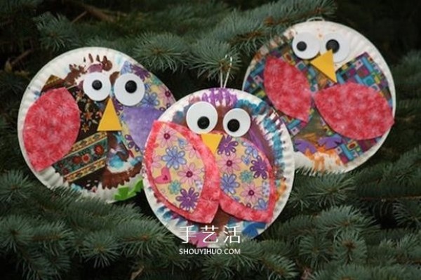 A small handmade paper dinner plate is made into a cute owl hanging ornament