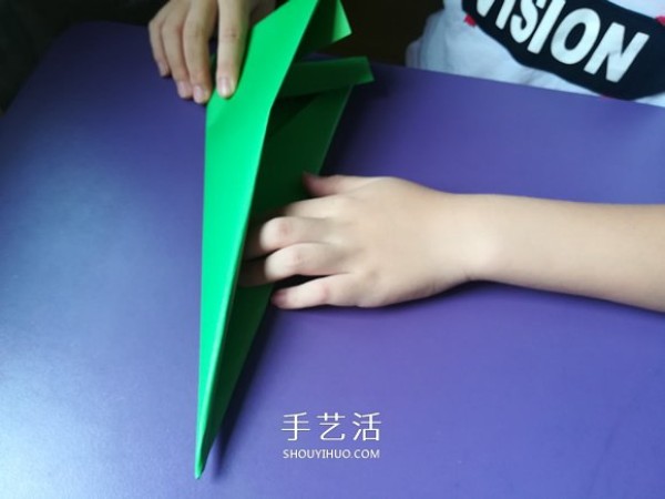 An eight-year-old boys origami sharing an illustrated tutorial on an origami fighter jet