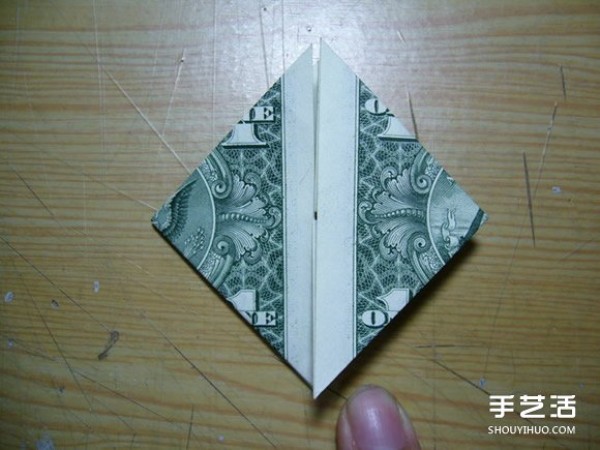 Illustration of the origami method of folding a dollar heart into a dollar bill