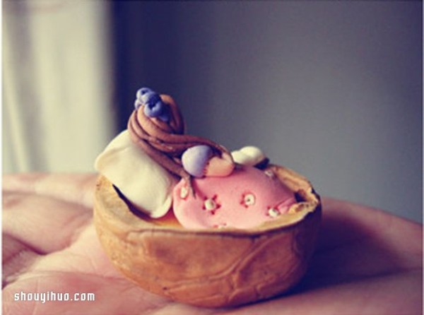 The little girl sleeping in the walnut shell is made of polymer clay