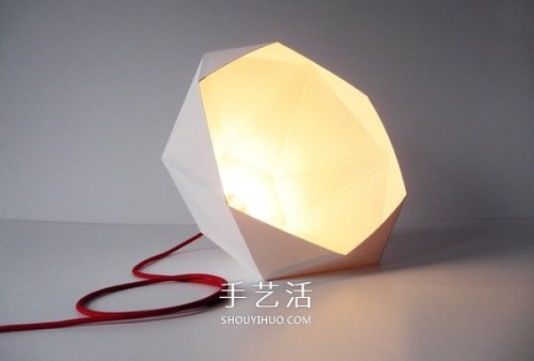 The picture of geometric lampshade made from cardboard is both artistic and futuristic