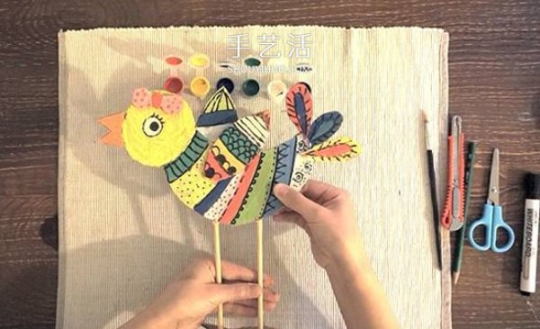 Kindergarten cardboard waste is used to make a colorful bird by hand