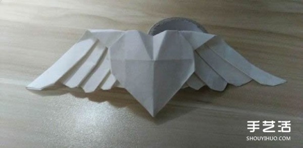 Flying origami heart with steps to fold a heart-shaped with wings