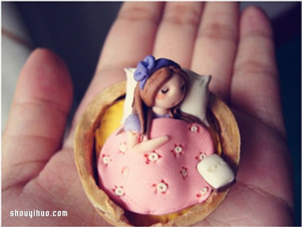 The little girl sleeping in the walnut shell is made of polymer clay