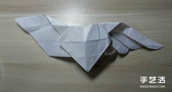 Flying origami heart with steps to fold a heart-shaped with wings