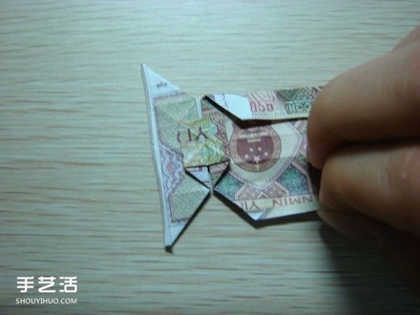 Paper money origami camera illustration and a detailed explanation of how to fold a dollar bill into a camera