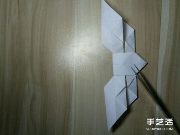 Flying origami heart with steps to fold a heart-shaped with wings