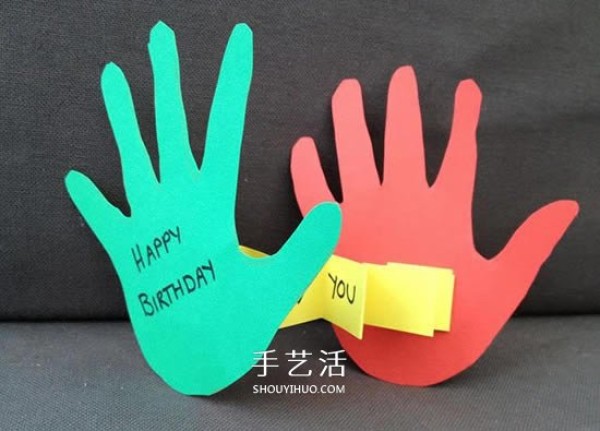 Creative childrens birthday cards are made with cardboard and two cute palms are cut