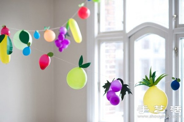 Balloons combined with paper-cut handmade fantasy fruit decorations