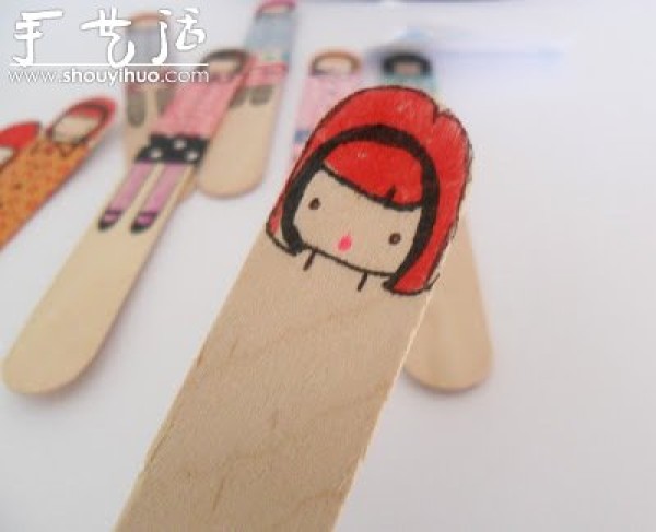 Cute little girl drawn on an ice cream stick