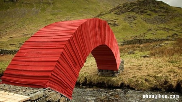 22,000 sheets of paper stacked to create a bridge that requires no glue or nails