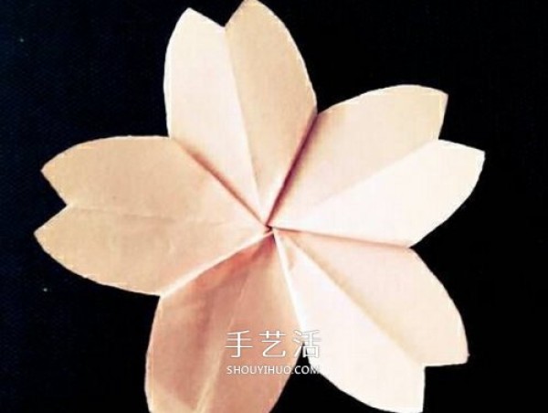 The simple method of folding the cherry blossoms is illustrated by first cutting the paper flowers and then folding the cherry blossoms