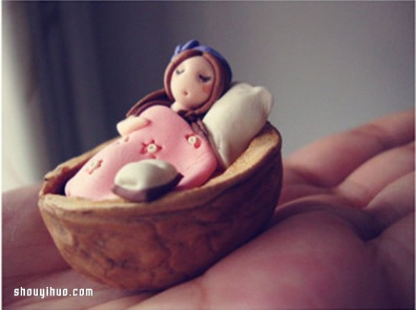 The little girl sleeping in the walnut shell is made of polymer clay