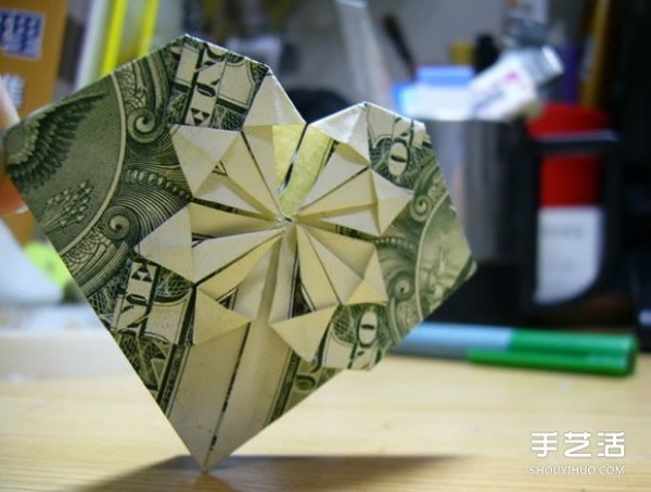 Illustration of the origami method of folding a dollar heart into a dollar bill