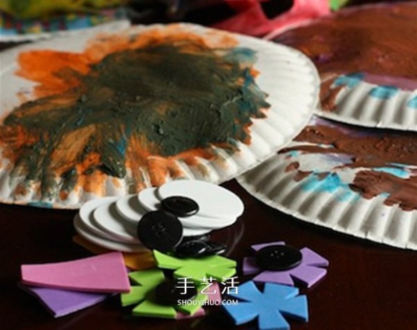 A small handmade paper dinner plate is made into a cute owl hanging ornament