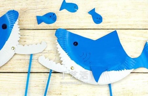 A small shark toy that uses paper dinner plate waste and a movable mouth