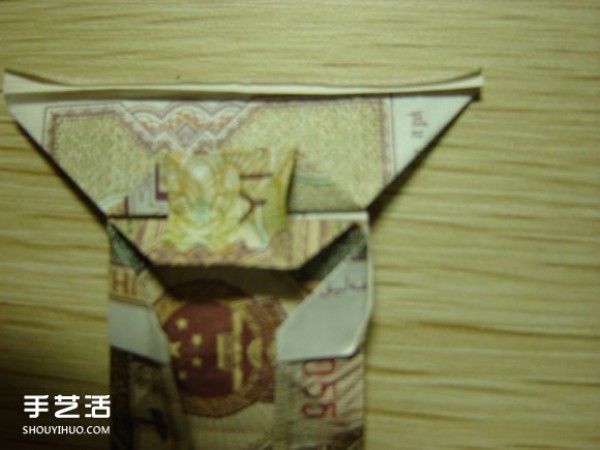 Paper money origami camera illustration and a detailed explanation of how to fold a dollar bill into a camera