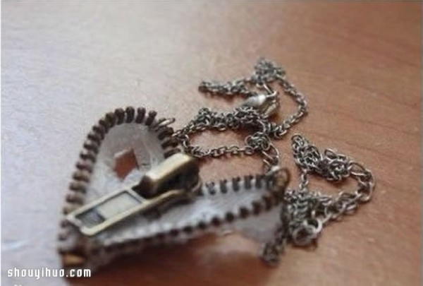 A broken zipper is turned into a treasure, a handmade personalized love necklace pendant