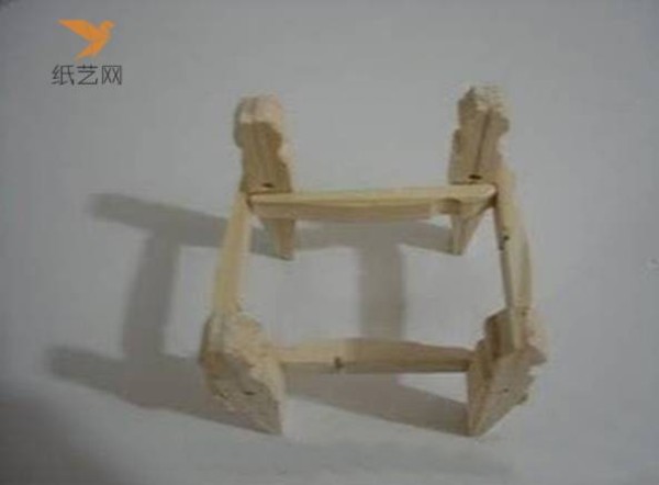 A small wooden chair for dolls made from unused wooden clips in the tutorial on turning waste into treasure