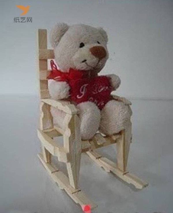 A small wooden chair for dolls made from unused wooden clips in the tutorial on turning waste into treasure