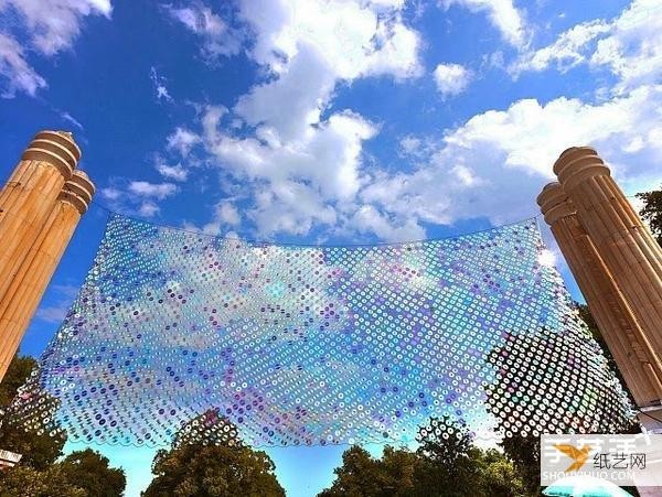 A giant iridescent curtain made from 6,000 discarded CDs