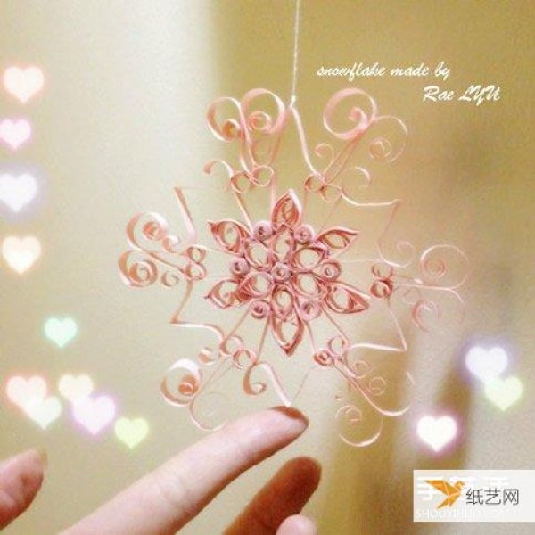 Illustration of how to make beautiful rolled paper snowflakes by hand using quilling paper