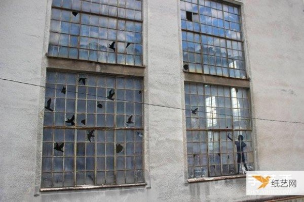 The artist’s humorous display makes the broken windows of abandoned buildings no longer scary