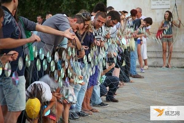 A giant iridescent curtain made from 6,000 discarded CDs