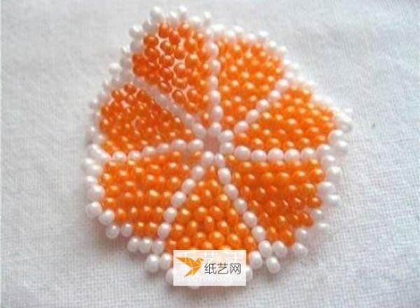 Use beads to create a personalized orange petal keychain