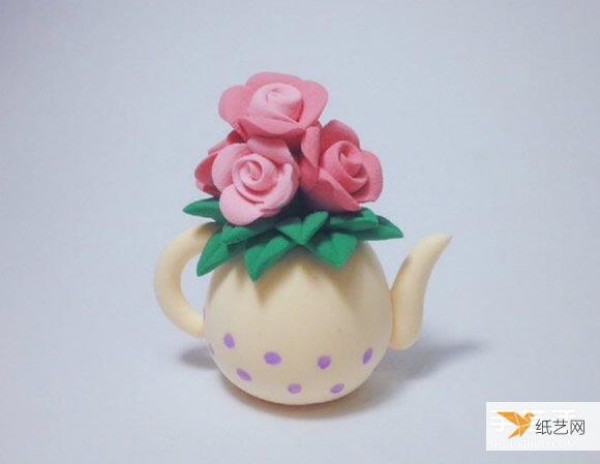 A kettle vase made of ultra-light clay and decorated with roses