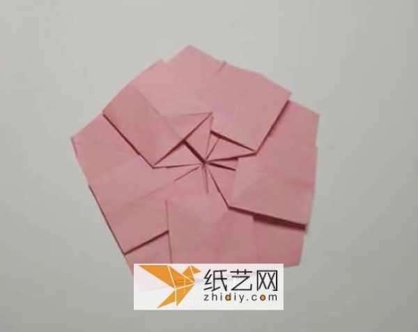 Tutorial on making origami Christmas flowers perfect for Christmas greeting cards