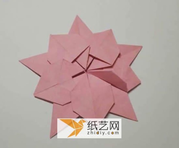 Tutorial on making origami Christmas flowers perfect for Christmas greeting cards