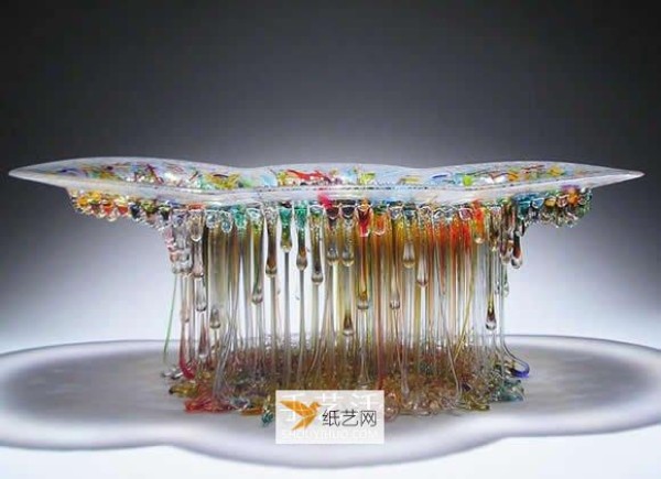 A dripping stained glass sculpture that transforms into a jellyfish