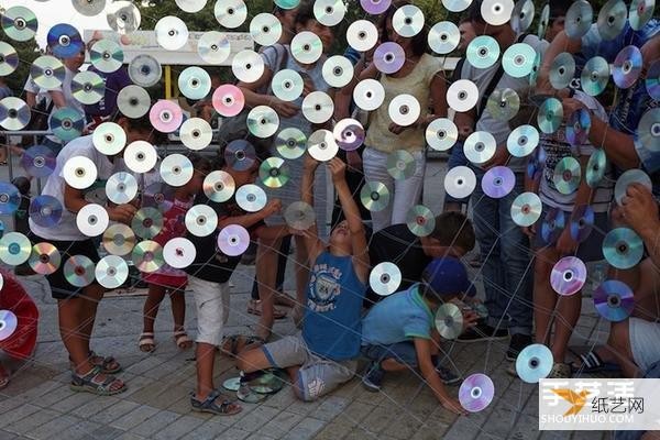 A giant iridescent curtain made from 6,000 discarded CDs