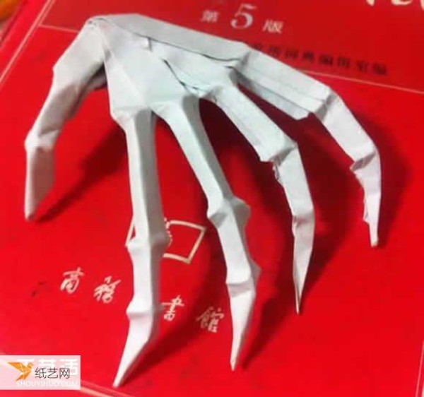 Illustration of the origami method of a very scary looking Halloween skeleton hand bone