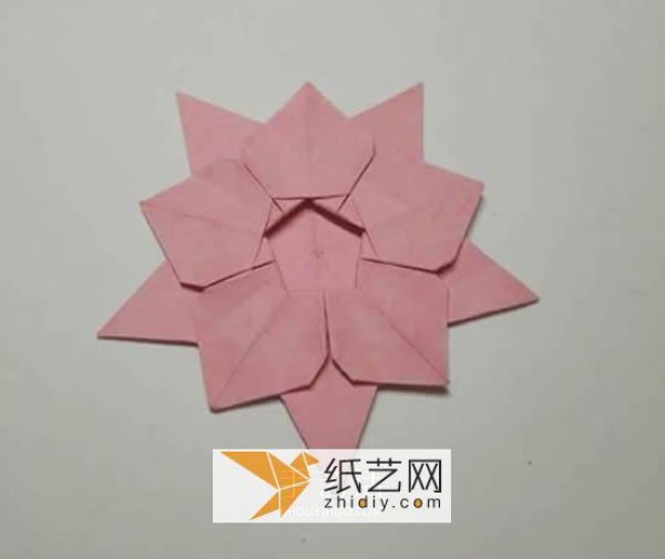 Tutorial on making origami Christmas flowers perfect for Christmas greeting cards