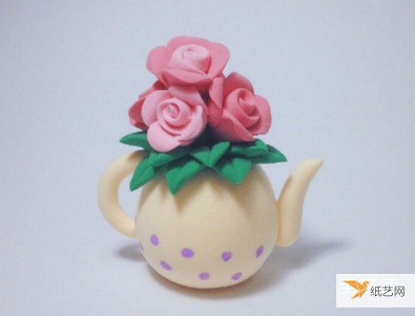 A kettle vase made of ultra-light clay and decorated with roses