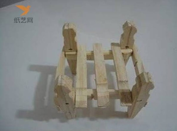 A small wooden chair for dolls made from unused wooden clips in the tutorial on turning waste into treasure