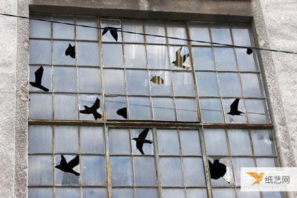 The artist’s humorous display makes the broken windows of abandoned buildings no longer scary