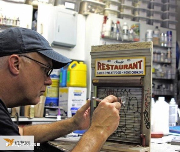 A handmade miniature model that recreates the traditional New York style shop street scene.