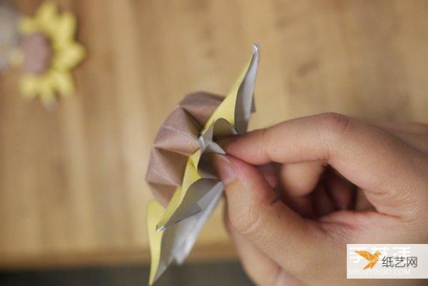 Illustration of the process of hand folding paper sunflower flowers