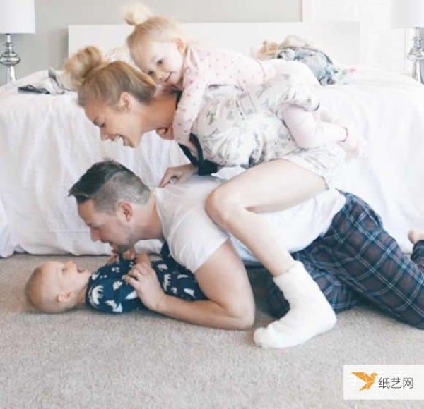 A creative family photo taken by a family of four wearing parent-child clothes