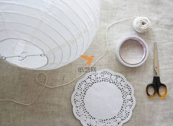 A beautiful lantern made of paper art hollow lace dessert paper mat