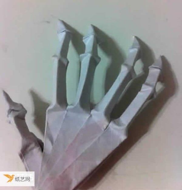 Illustration of the origami method of a very scary looking Halloween skeleton hand bone