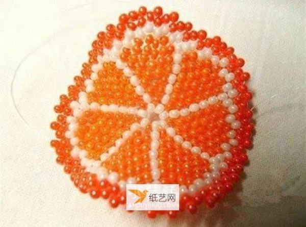 Use beads to create a personalized orange petal keychain