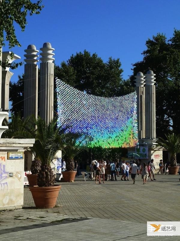 A giant iridescent curtain made from 6,000 discarded CDs